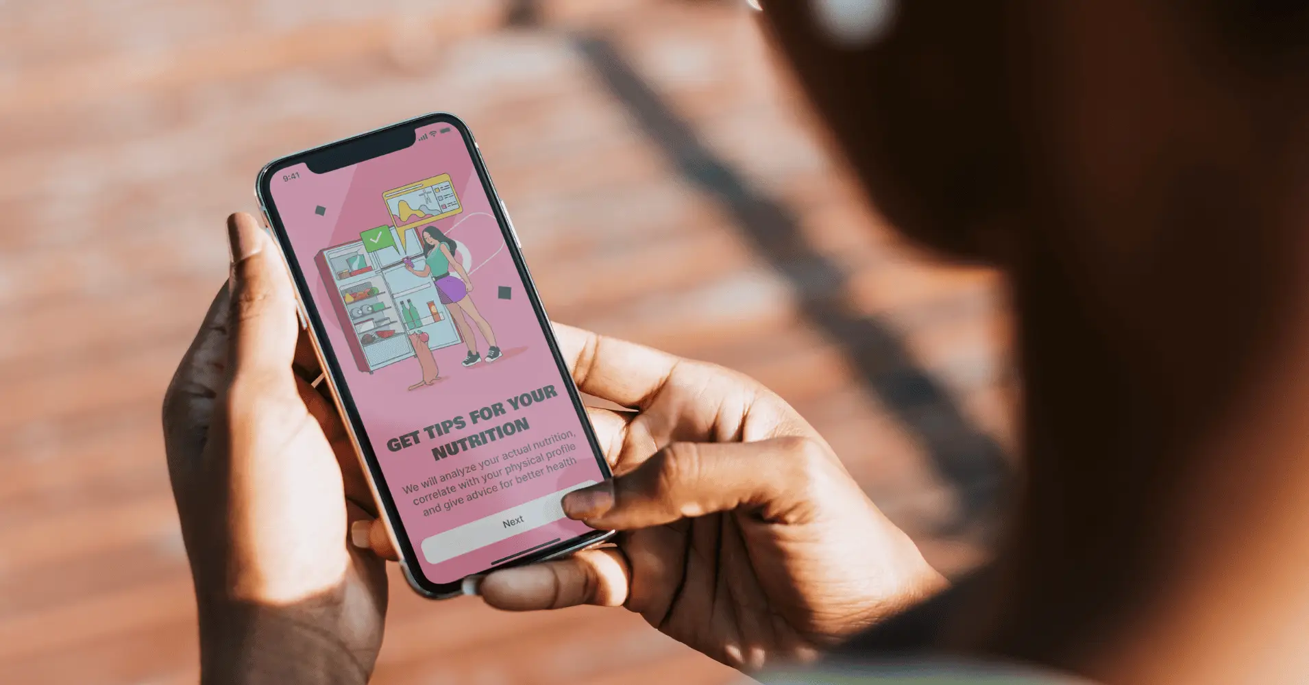 Person holding smartphone displaying nutrition tips app, close-up view.